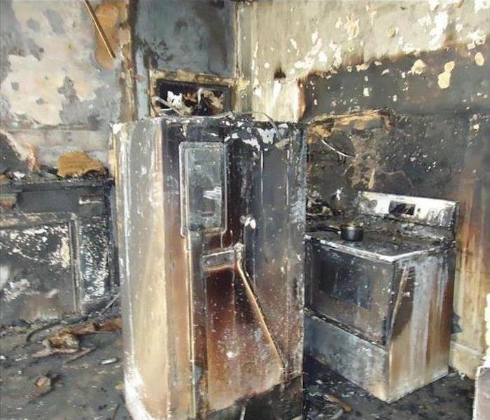 Burned kitchen, stove, refrigerator